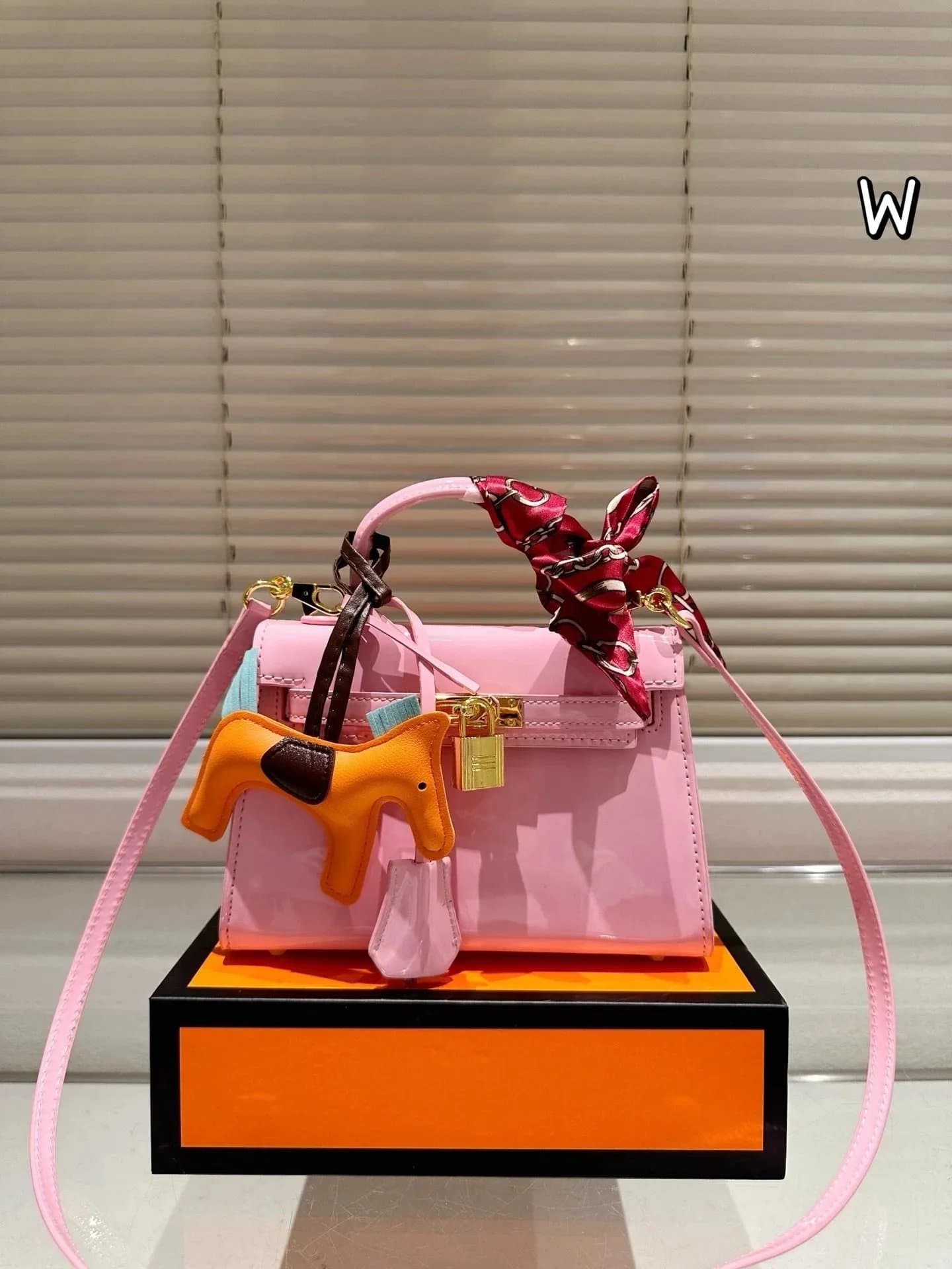 Hermès Kelly Mini Glossy Pink with Orange Horse Charm